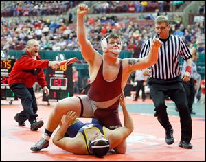 Genoa’s Jay Nino celebrates his victory against Archbold’s Travis Jaramillo in their 220-pound match Friday night. Nino won 5-2.