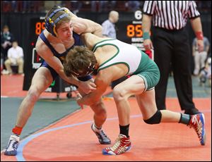 Woodmore’s Evan Ulinski, left, fends off Delta’s Jake Spiess in their 113-pound match during the Division III semifinals on Friday night. Ulinski rallied in the waning seconds for a 5-3 victory.