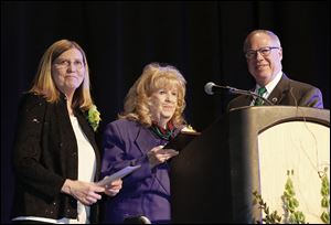 Sandra Drabik, left, and her husband, Mayor D. Michael Collins, present former Toledo Councilman Betty Shultz with a key to the city in honor of her 30-plus years of service.