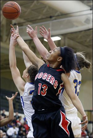 Rogers' Tori Easley, center, shoots against Clyde's Kelsey Michaels, left, and Amanda Cahill during the Division II district final.