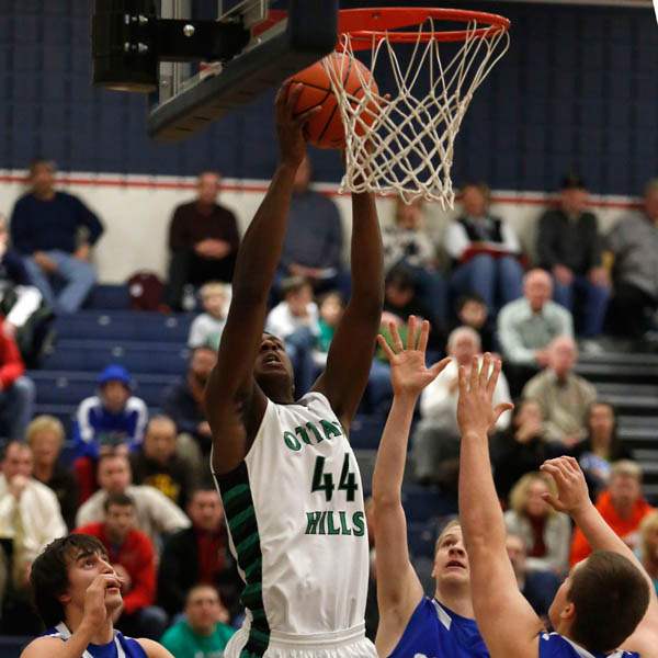 Ottawa-Hills-Ellis-Cummings-goes-up-to-dunk-over-Tiffin-Calvert-defenders