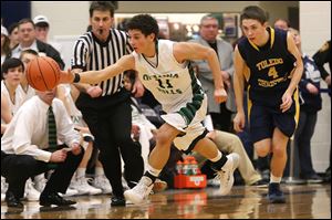 Ottawa Hills freshman Hunter Sieben steals the ball from Toledo Christian's Matthew Brumbaugh in Friday night’s Division IV district final. Sieben scored 10 points for the Green Bears.