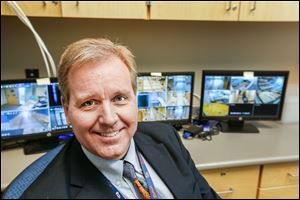 Maplewood Principal Ed Eding sits in front of closed-circuit views of the school. In the event of an armed intruder, he must lock himself in this room and report to the school where the intruder is located.