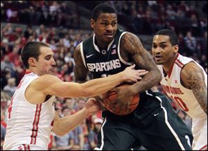 Ohio State's Aaron Craft, left, steals the ball from Michigan State's Keith Appling during the first half Sunday in Columbus.