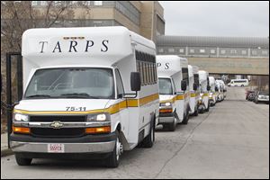 Toledo Area Regional Paratransit Service buses wait in front of the Amtrack station in Toledo.