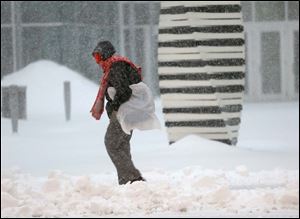 Rita Wheeler battles the snow and wind to make here way to work in downtown Toledo.