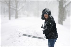 A bundled up Wendy Hayes battles the falling snow at her home on the corner of Christie and Densmore in Old Orchard.