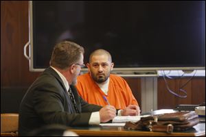 Jason Risenburg, 38, right, sits next to his attorney Jon Ickes, left, during his sentencing in Sandusky County Common Pleas Court Tuesday.