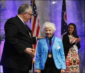 Joseph H. Zerbey IV, president and general manager of the Blade, left, gives an award to Dr. Phyllis Morton.