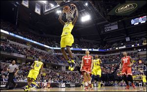 Michigan guard Caris LeVert dunks in the first half.