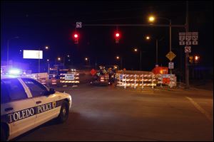 Workers set up barricades to the Anthony Wayne Bridge as repairs to the bridge are set to begin.