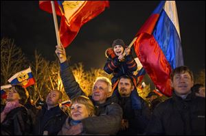 Pro-Russian demonstrators celebrate in Sevastopol, Ukraine, on Monday after residents in Crimea voted  to secede from Ukraine and join Russia.