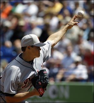 Detroit Tigers starting pitcher Kyle Lobstein throws in the first inning of an exhibition spring training baseball game against the New York Mets.