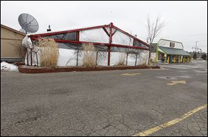 Arnie’s Again Bar and Grill, left, and El Nuevo Vallarta restaurants on West Central are slated for demolition as part of a Westgate development plan that drew mixed reviews Wednesday night.