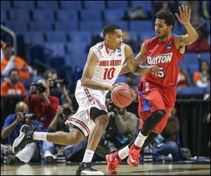 Ohio State’s LaQuinton Ross drives past Dayton’s Devin Oliver. Ross, a junior, might enter the NBA draft.