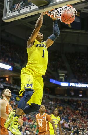 Michigan forward Glenn Robinson III slams down two points. He scored 14 points to help the Wolverines improve to 27-8.