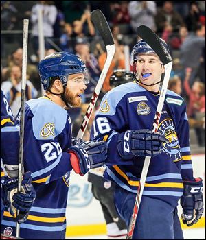 Jesse Messier, left, celebrates scoring against Gwinnett with teammate Dean Chelios. Chelios and his brother, Jake, both signed with Toledo on Saturday.