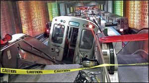 A Chicago Transit Authority train car rests on an escalator at the O'Hare Airport station after it derailed early today in Chicago. More than 30 people were injured. 