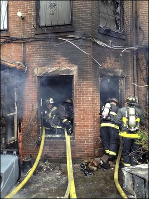 Firefighters battling the multi-alarm fire at a four-story brownstone in the Back Bay neighborhood near the Charles River.