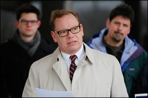 With supporters behind him, Joe Celusta announces his candidacy for the District 2 seat on Toledo City Council during a news conference outside the former Clarion on South Reynolds Road.