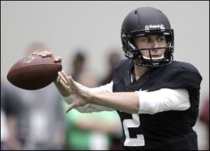 Manziel caused a stir by choosing to wear a helmet and shoulder pads during the workout.