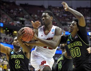 Whitmer graduate and Wisconsin forward Nigel Hayes fights for a rebound against Baylor's Royce O'Neale (00) during the first half of an NCAA men's college basketball tournament regional semifinal, Thursday in Anaheim, Calif. ASSOCIATED PRESS