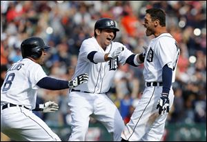 Detroit Tigers' Ian Kinsler, right, celebrates hitting a walkoff-single with teammates Tyler Collins, left, and Nick Castellanos against the Kansas City Royals.