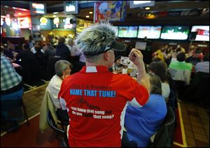 Dave Zwayer gets the crowd pumped as he hosts Dave Z and Branden's Name That Tune! trivia night at Ralphie's on Monroe Street.