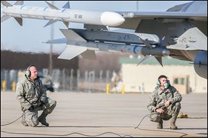 Tech. Sgt. Dan Goble, left, and Airman 1st Class Brett Sloan, right, get ready for one of the jets to take flight. 