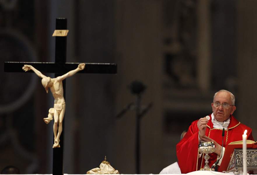 Pensive pope joins faithful at Colosseum for Good Friday torch-lit