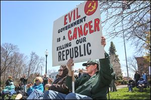 Bob Spudie of Perrysburg holds his sign up as he joins other area residents at the Northwest Ohio Tax Day Tea Party Rally at Hood Park in Perrysburg. About 50 people, including several local politicians and candidates, were on hand to talk about politics.