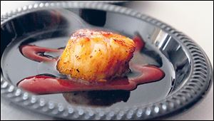 Coriander dusted scallops with a blood orange puree from Poco Piatti.