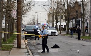 Toledo police rope off a shooting scene on 13th Street between Madison and Jefferson today.