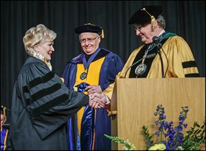 Commencement speaker Deborah L. Wince-Smith, president and CEO of the U.S. Council on Competitiveness, is bestowed an honorary doctorate in public administration degree from Joseph H. Zerbey IV, chairman of the university’s Board of Trustees and president and general manager of The Blade, center, and Lloyd Jacobs, university president.