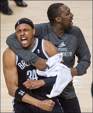 Brooklyn’s Paul Pierce, left, and Andray Blatche celebrate after defeating Toronto in Game 7.