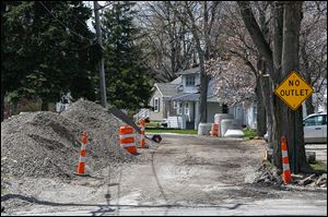 Installation of new sanitary sewer and water lines has left Hillside Drive in Rossford torn up. The city’s design consultant has given a city council committee  three plans to repair the street.