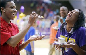 Daveon Lofton, left,  laughs with fellow Waite sophomore Dajanay Wells as he offers to feed her cake after the ceremony. Another event is set for today. 