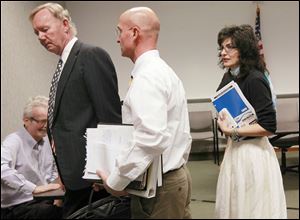 John Irish, left, Dan DeAngelis, and Gina Kaczala leave after the committee members presented their recommendations on Friday. Ms. Kaczala says she will try to convince the secretary of state to give her more time on the job.