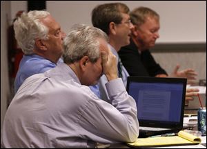 From left: Tony DeGidio, board of elections chairman Ron Rothenbuhler, Jon Stainbrook, and John Irish attend the meeting.