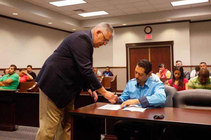 CTY-COCKFIGHT15pSwanton-Bailiff-Tim-Coll-helps-Gustavo-Cabrera-with-paperwork