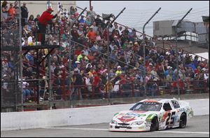 Justin Boston crosses the finish line to win the ARCA's Menards 200 at the Toledo Speedway.