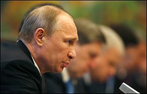 Russia's President Vladimir Putin talks during his meeting with China's President Xi Jinping, ahead of the fourth Conference on Interaction and Confidence Building Measures in Asia (CICA) summit in Shanghai, China today.