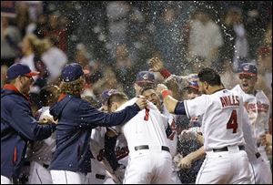 The Cleveland Indians celebrate after Michael Brantley hit a game-winning solo home run off Detroit Tigers relief pitcher Al Alburquerque in the tenth inning.