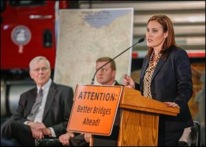 Ohio  Lt. Gov. Mary Taylor announced the bridge improvement projects for Lucas and Wood counties on Tuesday. Looking on are Raymond Huber, left, Wood County engineer, and Todd Audet, deputy director of the Ohio Department of Transportation.