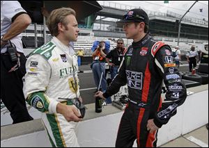 Kurt Busch, right, talks with Ed Carpenter during practice for Indianapolis 500.