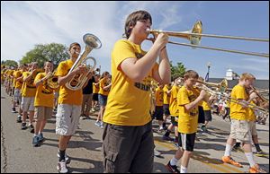 Aaron Polaff, 13, center, plays his trombone with the Perrysburg Junior High School band as the march in the parade.