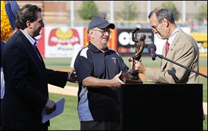 Jim Weber accepts his statue from International League president Randy Mobley after being inducted into the IL Hall of Fame.