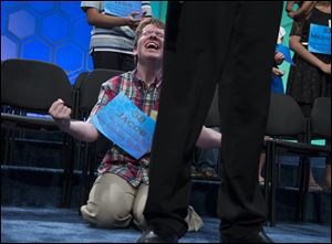 Jacob Williamson of Cape Coral, Fla., celebrates after learning he made the final round of the National Spelling Bee today in Oxon Hill, Md.