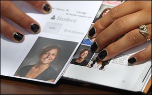 Wasatch High School sophomore Shelby Baum, 16, points to yearbook proof, left, and her altered school yearbook photo, right, in Heber City, in Utah