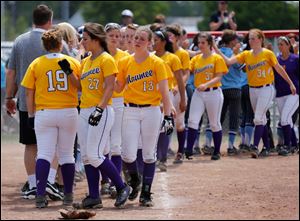 Maumee players react to their loss to Lima Bath during the Division I regional softball final Saturday in Bucyrus, Ohio. Lima Bath defeated Maumee 12-3.